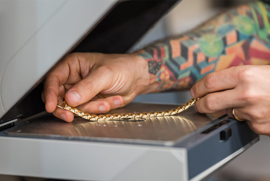 Weighing gold on jewelry scale for gold pricing